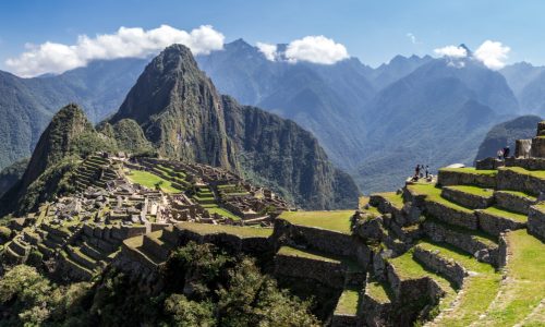 Panoramic view of Machu Picchu ruins in Peru. Behind we can appreciate big and beautiful mountains full of green vegetation. Archaeological site, UNESCO World Heritage